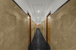 a hallway with wooden walls and a long corridor at Super Townhouse Financial District Gachibowli Formerly Srinika Inn in Hyderabad
