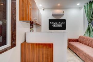 a living room with a couch and a tv at Super Townhouse Telapur Junction Formerly Fortune Inn in Hyderabad
