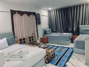 a hotel room with two beds and a window at Nada HOTEL in Cairo +31 photos