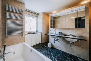 a bathroom with two sinks and a bath tub at Villa Limoncello in Hard +67 photos