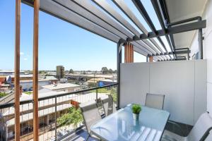 a view from the balcony of a apartment with a table and chairs at Magnificent Apartment + FREE car park near CBD in Adelaide
