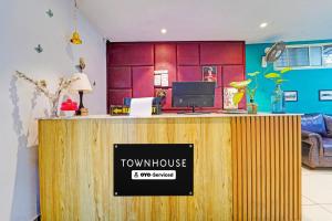 a town house with a counter with a sign on it at Townhouse Kozhencherry Formerly The Beige Hotel in Pathanāmthitta