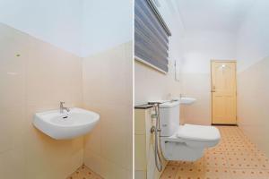 a bathroom with a sink and a toilet at Townhouse Kozhencherry Formerly The Beige Hotel in Pathanāmthitta