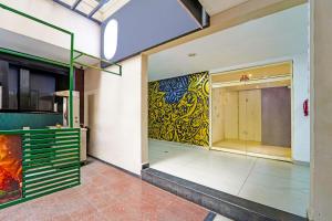 a store front with a painting on the wall at Townhouse Kozhencherry Formerly The Beige Hotel in Pathanāmthitta +24 photos