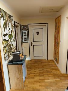a hallway with a door and a table with a laptop on it at By Wallner's in Sankt Leonhard