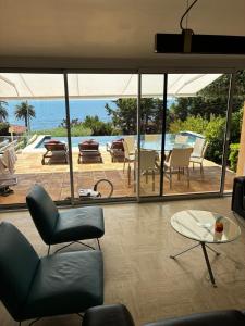 a living room with a view of the ocean at Villa Naussica in Saint-Raphaël