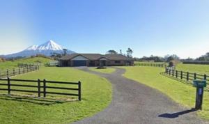 a road leading to a farm with a snow covered mountain at Peter Country Retreat in Midhirst