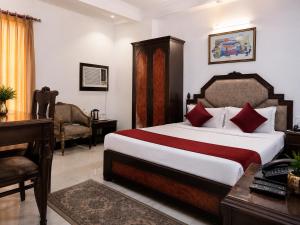 a hotel room with a bed and a desk and a desk at Hotel Sunshine - Karol Bagh Budget Stay at New Delhi in New Delhi +32 photos