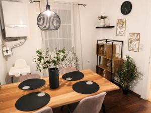 a dining room table with black and white plates on it at Faraway Homes Studio Enns #14 in Enns +2 photos