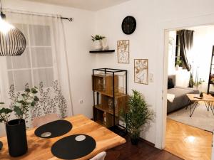 a living room with a table and a room with a couch at Faraway Homes Studio Enns #14 in Enns