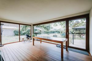 a living room with a table and a large window at Villa Limoncello in Hard