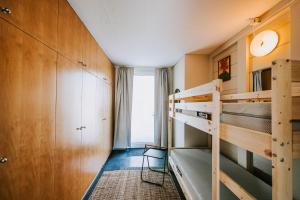 a bedroom with two bunk beds and a window at Villa Limoncello in Hard