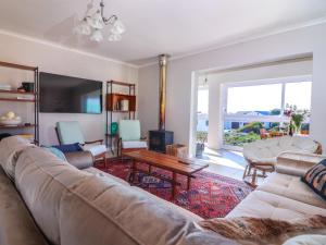 a living room with a couch and a tv at Bluemist Accommodation in Gansbaai