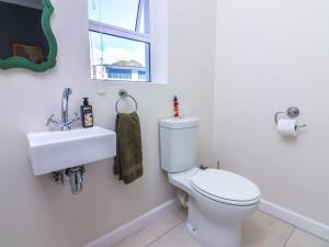 a bathroom with a toilet and a sink at Bluemist Accommodation in Gansbaai +47 photos