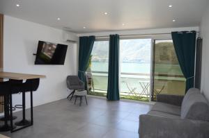 a living room with a couch and a table at Sun beach in Tresserves