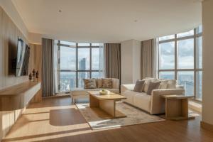 a living room with a couch and a table at Tower Club at lebua in Bangkok