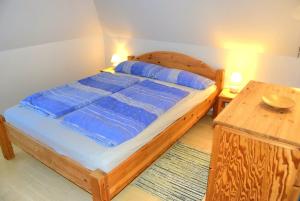 a bedroom with a wooden bed and a wooden table at Zaumseil, Axel Fe-App "oben" in Schönberg