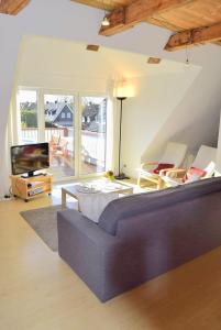 a living room with a couch and a tv at Zaumseil, Axel Fe-App "oben" in Schönberg