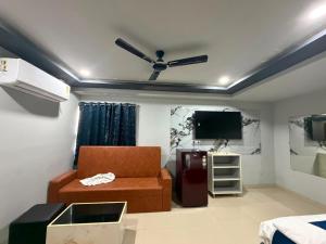 a living room with a couch and a tv at HOTELc3 in Visakhapatnam