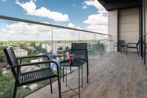 a balcony with chairs and a table on a building at Azamra in Uman