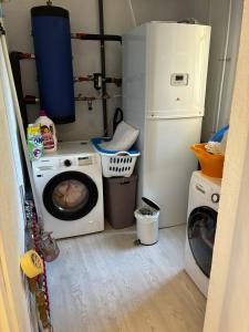 a laundry room with a washing machine and a washer at Villa Naussica in Saint-Raphaël