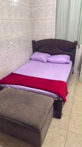 a bed with two pillows on top of it at Pousada Dois Irmão in Uberaba