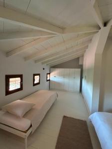 a bedroom with a large bed and two windows at The Hill House in Argalasti