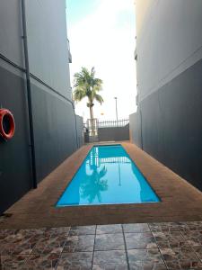 a swimming pool in the middle of a building at Margate Boulevard - Seaview Apartment in Margate +10 photos