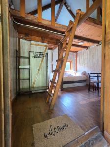 a room with a bunk bed and a ladder at camping los pradones in Cudillero