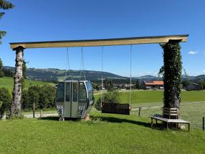 a car on a swing in a field at Hus8 Krumbach in Krumbach