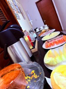 a table with plates of food on top at Pousada Center in Barreirinhas