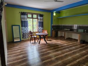 a room with a table and chairs and a desk at Sharma Residency in Dithur +3 photos