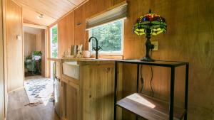 a kitchen with a sink and a lamp on a counter at Penrallt in Benllech +115 photos
