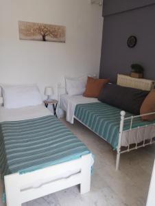 a room with two beds and a couch at Αλέξανδρος 3 in Myrina