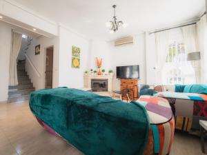 a living room with a large green couch in it at Luxury Private Pool Villa Campoverde in Pinar de Campoverde