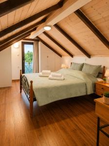 a bedroom with a large bed in a attic at Marilena's Houses in Kallithea Rhodes