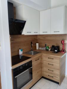 a kitchen with white cabinets and a sink at Αλέξανδρος 3 in Myrina +4 photos