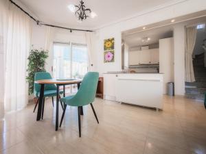 a kitchen and dining room with a table and chairs at Luxury Private Pool Villa Campoverde in Pinar de Campoverde