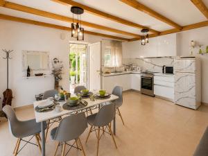 a kitchen and dining room with a table and chairs at Marilena's Houses in Kallithea Rhodes