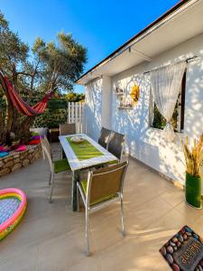 a patio with a table and chairs and a pool at Marilena's Houses in Kallithea Rhodes