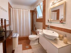 a bathroom with a toilet and a sink and a mirror at Marilena's Houses in Kallithea Rhodes +36 photos