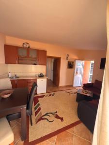 a living room with a table and a kitchen at Alexandra in Prijevor