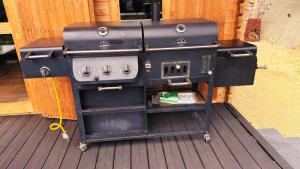 a stove sitting on top of a wooden deck at Babia Góra View House in Kocierz Moszczanicki +14 photos