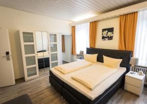a bedroom with a large bed in a room at Hotel Restaurant Ketterer am Kurgarten in Triberg +69 photos