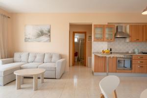 a living room with a couch and a kitchen at Kos Happy living in Lampi