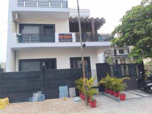 a house with potted plants in front of it at PLAY HOTEL PREET RESIDENCY couple friendly in Greater Noida