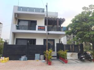a large white house with a balcony on top of it at PLAY HOTEL PREET RESIDENCY couple friendly in Greater Noida