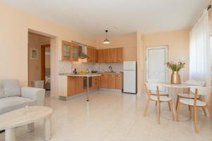 a kitchen and living room with a table and a couch at Kos Happy living in Lampi +22 photos
