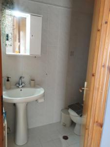 a bathroom with a sink and a toilet at Αλέξανδρος 3 in Myrina