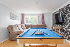 a living room with a pool table in it at Talbot House by Grandeur Property in Bournemouth